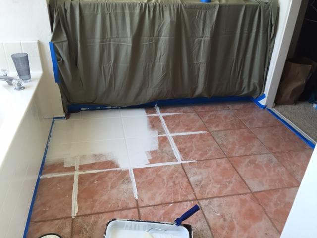 DIY for painting tile floors featured by top US lifestyle blog, Domestic Blonde: applying primer