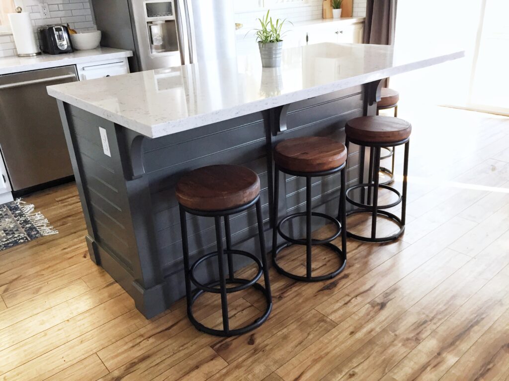 kitchen island with bar stools and storage