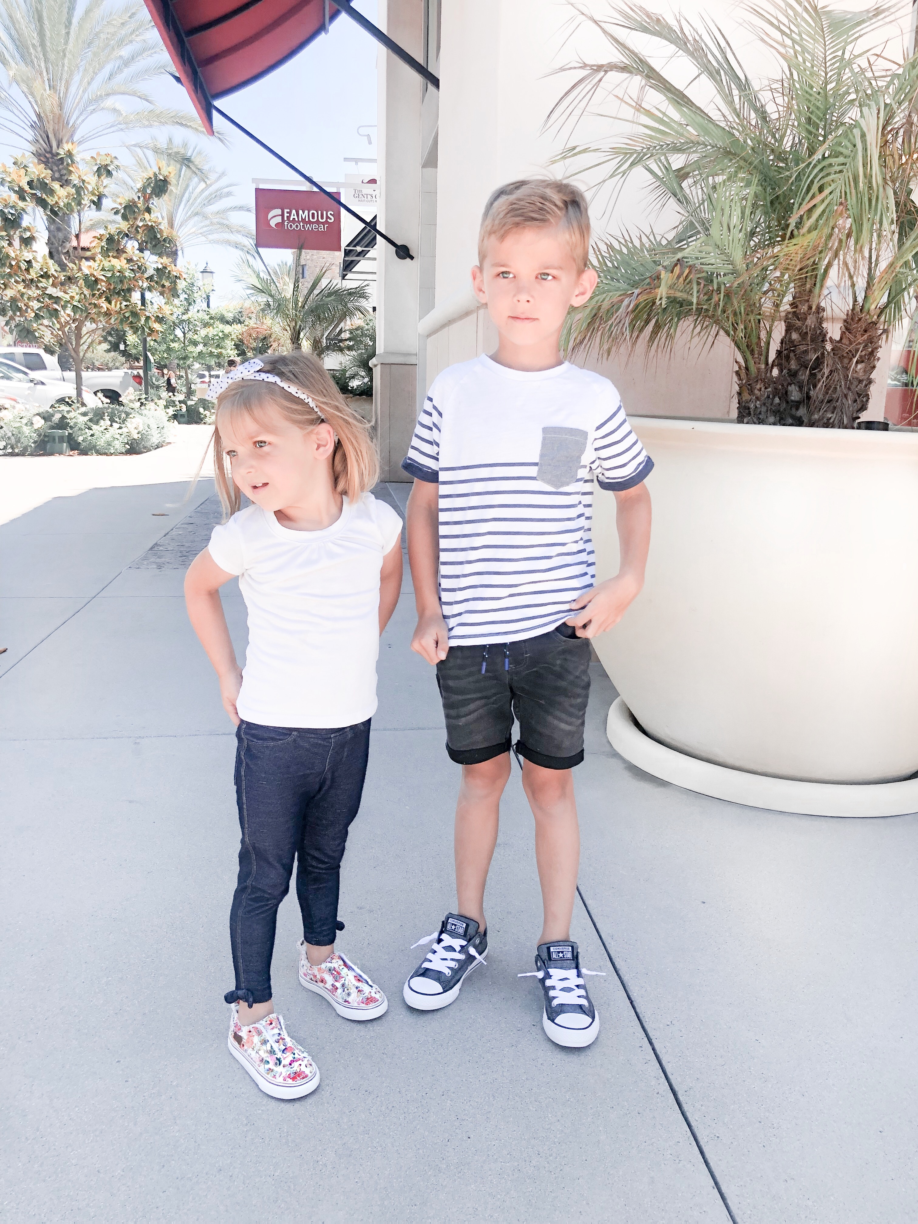 Back To School Shoes from Famous Footwear by popular San Diego fashion blog, Domestic Blonde: image of a little boy and girl standing outside of a famous footwear and wearing their new shoes.