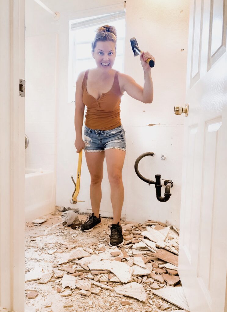 Kids Bathroom by popular San Diego interior design blog, Domestic Blonde: image of a woman demoing a bathroom. 