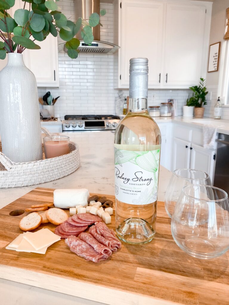 Rodney Strong Wines by popular San Diego lifestyle blog, Domestic Blonde: image of Rodney Strong white wine resting on a charcuterie board. 