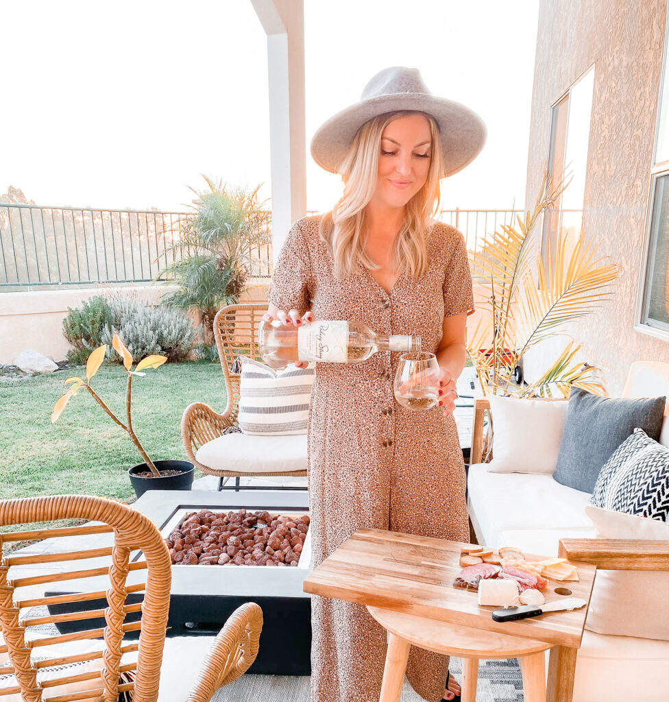 Rodney Strong Wines by popular San Diego lifestyle blog, Domestic Blonde: image of a woman pouring a glass of white Rodney Strong wine. 