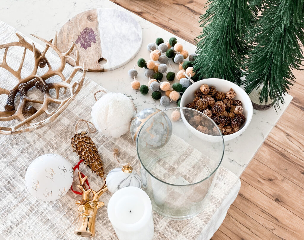 Joann Holiday Decor by popular San Diego life and style blog, Domestic Blonde: image of Joann antler bowl, white and gold ornaments, and a gold deer head and gold embossed pinecone. 