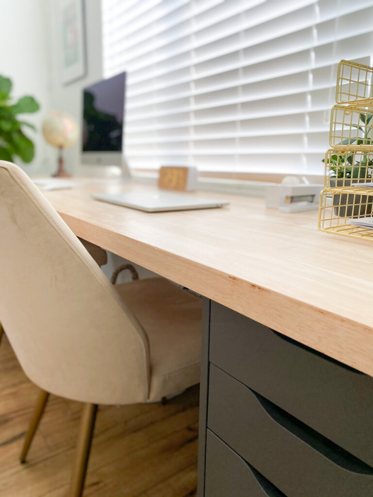DIY Home Office Desk by popular San Diego DIY blog, Domestic Blonde: image of a home office desk, fabrick chairs, Mac laptop, Mac Desktop, and gold wire baskets. 